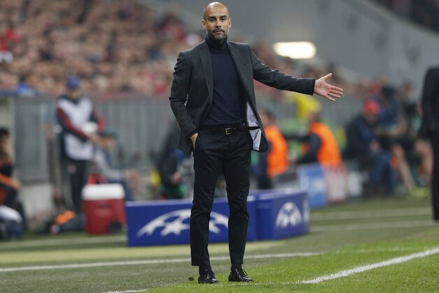 Bayern head coach Pep Guardiola gestures during the Champions League semifinal second leg soccer match between Bayern Munich and Real Madrid at the Allianz Arena in Munich, southern Germany, Tuesday, April 29, 2014. (AP Photo/Matthias Schrader)