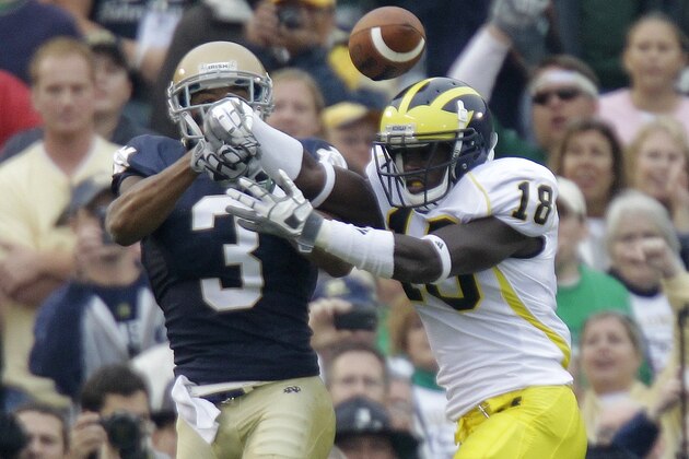 Michigan cornerback James Rogers, right, breaks up a pass in the end zone to Notre Dame wide receiver Michael Floyd during the first half of an NCAA college football game in South Bend, Ind., Saturday, Sept. 11, 2010. (AP Photo/Michael Conroy)