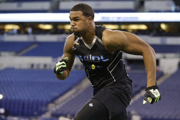 Louisville defensive lineman Marcus Smith runs a drill at the NFL football scouting combine in Indianapolis, Monday, Feb. 24, 2014. (AP Photo/Michael Conroy)