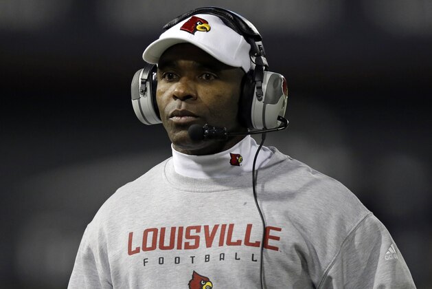 FILE - In tihs Dec. 5, 2013, file photo, Louisville head coach Charlie Strong watches from the sidelines in the first half of an NCAA college football game against Cincinnati in Cincinnati. New Texas football coach Strong says he is excited to lead one of the premier programs in the country, calling the Longhorns job a dream. In a statement released by the school formally announcing the hire Sunday, Jan. 5, 2014, Strong called Texas a special program because of its history, tradition and pride. (AP Photo/Al Behrman, File)