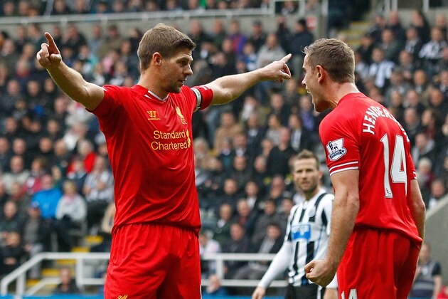 NEWCASTLE-UPON-TYNE, ENGLAND - OCTOBER 19: Steven Gerrard (L) of Liverpool celebrates scoring his 100th Premier League goal and his team's first with team-mate Jordan Henderson during the Barclays Premier League match between Newcastle United and Liverpool at St James' Park on October 19, 2013 in Newcastle-Upon-Tyne, England. (Photo by Paul Thomas/Getty Images)