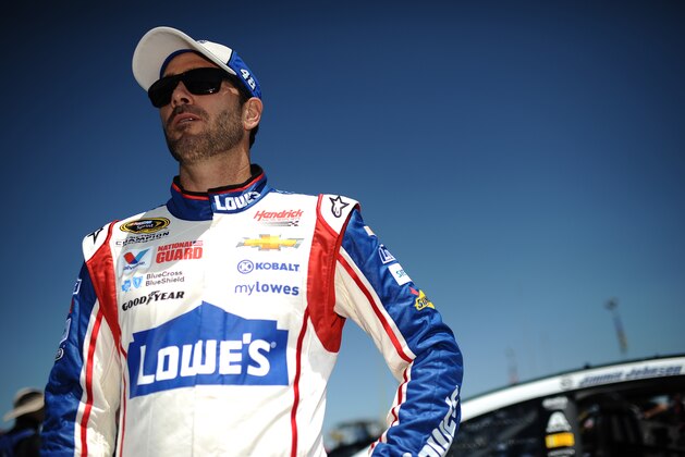 Jimmie Johnson stands by his car during qualifying for the NASCAR Sprint Cup Series auto race at Talladega Superspeedway, Saturday, May 3, 2014, in Talladega, Ala.  (AP Photo/Rainier Ehrhardt)