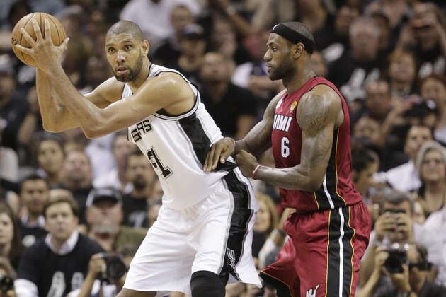 San Antonio Spurs' Tim Duncan is defended by Miami Heat's LeBron James, right, during the second half at Game 3 of the NBA Finals basketball series, Tuesday, June 11, 2013, in San Antonio. (AP Photo/Eric Gay)