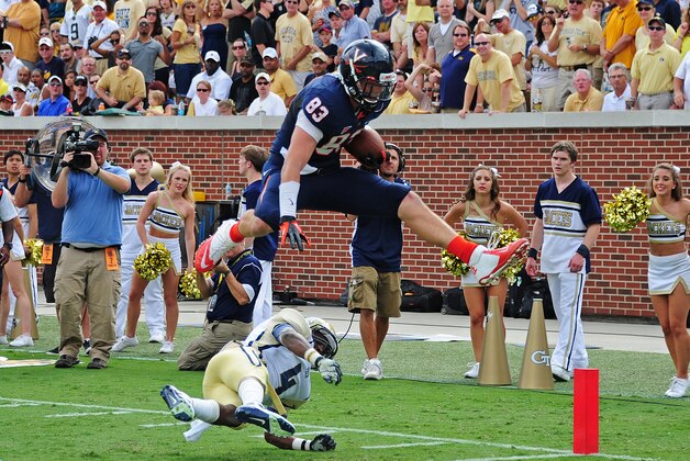 ATLANTA, GA - SEPTEMBER 15: Jake McGee #83 of the Virginia Cavaliers leaps over Jamal Golden #4 for a touchdown against the Georgia Tech Yellow Jackets at Bobby Dodd Stadium on September 15, 2012 in Atlanta, Georgia. (Photo by Scott Cunningham/Getty Images)