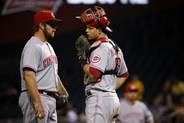 Cincinnati Reds catcher Devin Mesoraco, right, talks with relief pitcher J.J. Hoover (60) during the ninth inning of a baseball game against the Pittsburgh Pirates in Pittsburgh Monday, April 21, 2014. (AP Photo/Gene J. Puskar)