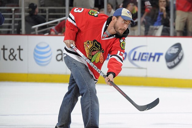 CHICAGO, IL - MARCH 21:  WWE Champion CM Punk shoots the puck in between periods during the NHL game between the Vancouver Canucks and the Chicago Blackhawks on March 21, 2012 at the United Center in Chicago, Illinois. (Photo by Bill Smith/NHLI via Getty Images)