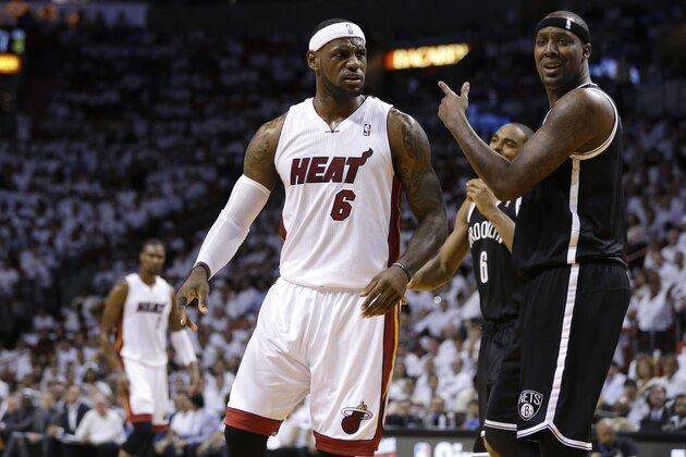 Brooklyn Nets' Paul Pierce, right, reacts to a call  by an official as Miami Heat's LeBron James (6) looks on in the first half of Game 1 in an Eastern Conference semifinal basketball game, Tuesday, May 6, 2014, in Miami.  (AP Photo/Lynne Sladky)