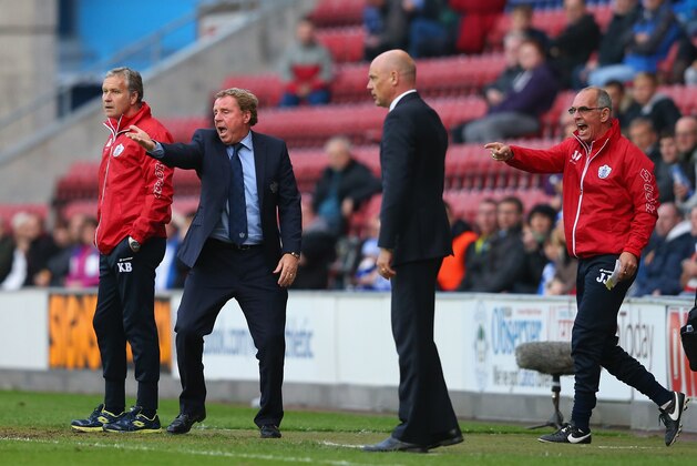 WIGAN, ENGLAND - MAY 09:  Harry Redknapp the manager of Queens Park Rangers and his assistant Joe Jordan react as Uwe Rosler the manager of Wigan Athletic looks on during the Sky Bet Championship Play Off Semi Final first leg match between Wigan Athletic and Queens Park Rangers at DW Stadium on May 9, 2014 in Wigan, England.  (Photo by Alex Livesey/Getty Images)