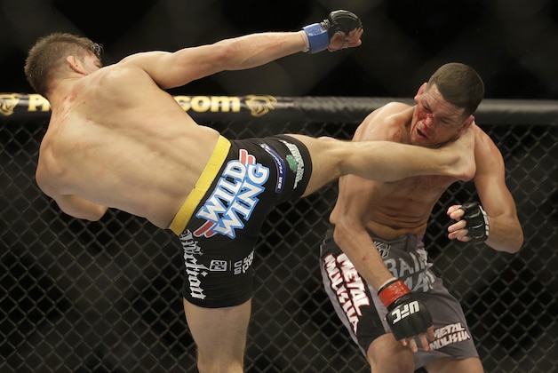 Josh Thomson, left, kicks Nate Diaz during the second round of a UFC lightweight mixed martial arts fight in San Jose, Calif., Saturday, April 20, 2013. Thomson won by technical knockout in the second round. (AP Photo/Jeff Chiu)