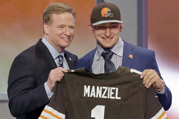 Texas A&M quarterback Johnny Manziel poses with NFL commissioner Roger Goodell after being selected by the Cleveland Browns as the 22nd pick in the first round of the 2014 NFL Draft, Thursday, May 8, 2014, in New York.  (AP Photo/Frank Franklin II)