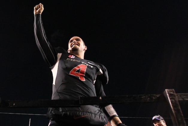 Fresno State's Derek Carr raises his fist to the crowd as he celebrates a Mountain West title in the second half of an NCAA college football game in Fresno, Calif., Saturday, Dec. 7, 2013. (AP Photo/Gary Kazanjian)