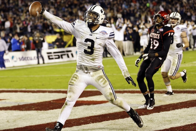 FILE - In this Dec. 20, 2012, file photo, BYU linebacker Kyle Van Noy holds out the ball as he scores on a 17-yard interception return during the fourth quarter of the Poinsettia Bowl NCAA college football game against San Diego State, in San Diego. This weekend, Texas faces a stingy BYU defense that was one of the country's best last season.  (AP Photo/Lenny Ignelzi, File)
