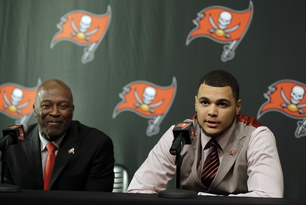 Tampa Bay Buccaneers first round draft pick Mike Evans, right, answers a question during a news conference as head coach Lovie Smith looks on Friday, May 9, 2014, in Tampa, Fla. Evans, a wide receiver from Texas A&M, was the seventh player chosen. (AP Photo/Chris O'Meara)