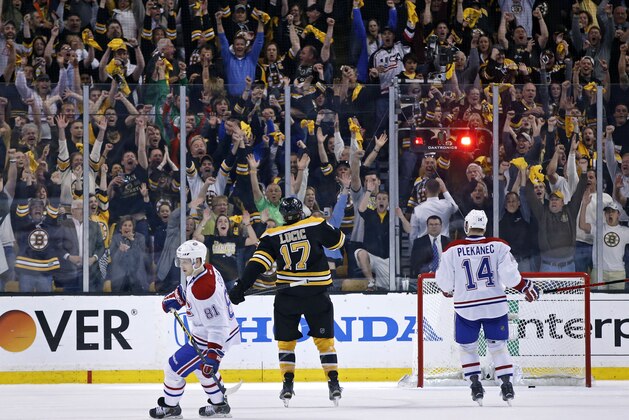 Boston Bruins left wing Milan Lucic (17) celebrates his empty-net goal with fans as Montreal Canadiens center Lars Eller (81) and center Tomas Plekanec (14) skate off during the third period in Game 2 of an NHL hockey second-round playoff series in Boston, Saturday, May 3, 2014. The Bruins won 5-3. (AP Photo/Elise Amendola)