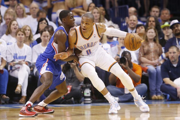 Oklahoma City Thunder guard Russell Westbrook (0) drives against Los Angeles Clippers guard Darren Collison (2) in the first quarter of Game 2 of the Western Conference semifinal NBA basketball playoff series in Oklahoma City, Wednesday, May 7, 2014. (AP Photo/Sue Ogrocki)