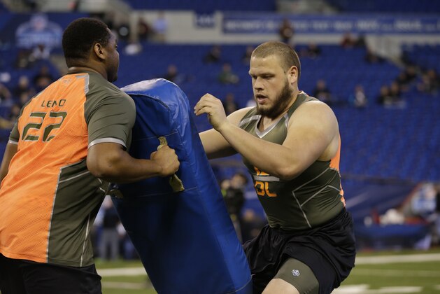 Nevada offensive lineman Joel Bitonio runs a drill at the NFL football scouting combine in Indianapolis, Saturday, Feb. 22, 2014. (AP Photo/Michael Conroy)
