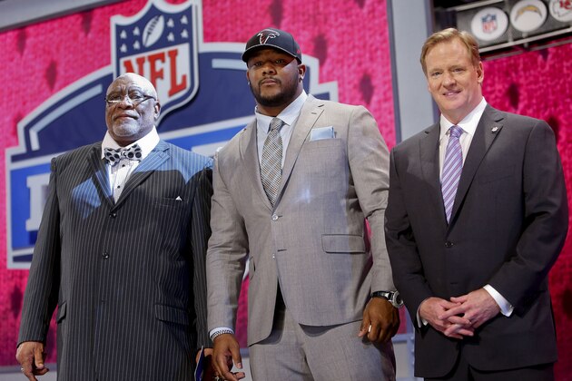 Minnesota defensive tackle Ra'Shede Hageman, center, poses for photos with NFL commissioner Roger Goodell, right, and former NFL player Claude Humphrey after being selected by the Atlanta Falcons as the 37th pick during the second round of the 2014 NFL Draft, Friday, May 9, 2014, in New York. (AP Photo/Jason DeCrow)