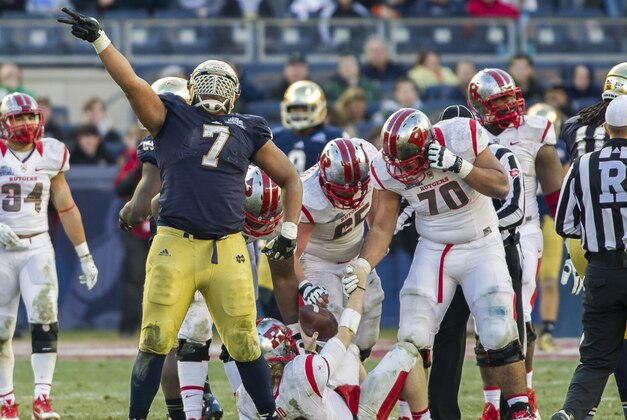 Dec 28, 2013; Bronx, NY, USA; Notre Dame Fighting Irish defensive end Stephon Tuitt (7) celebrates after sacking Rutgers Scarlet Knights quarterback Chas Dodd (19) in the fourth quarter of the Pinstripe Bowl at Yankee Stadium. Notre Dame won 29-16. Mandatory Credit: Matt Cashore-USA TODAY Sports
