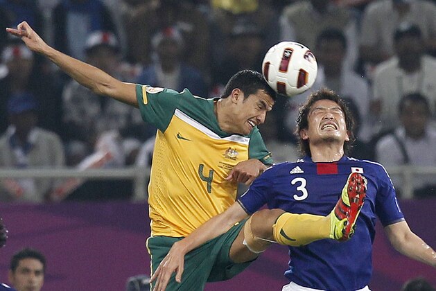 Australia's Tim Cahill, left, and Japan's Daiki Iwamasa in action during the AFC Asian Cup final soccer match in Doha, Qatar, Saturday, Jan. 29, 2011. (AP Photo/Hassan Ammar)