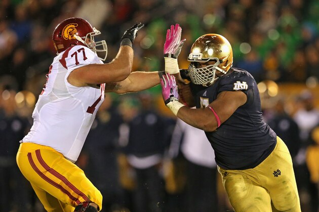 SOUTH BEND, IN - OCTOBER 19: Stephon Tuitt #7 of the Notre Dame Fighting Irish rushes against Kevin Graf #77 of the University of Southern California Trojans at Notre Dame Stadium on October 19, 2013 in South Bend, Indiana. Notre Dame defeated USC 14-10. (Photo by Jonathan Daniel/Getty Images)