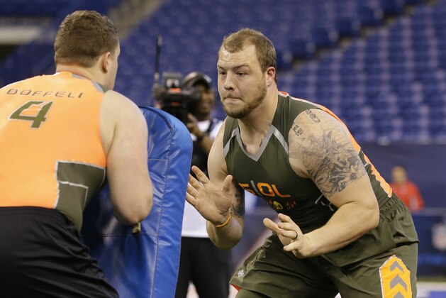 Missouri offensive lineman Justin Britt runs a drill at the NFL football scouting combine in Indianapolis, Saturday, Feb. 22, 2014. (AP Photo/Michael Conroy)