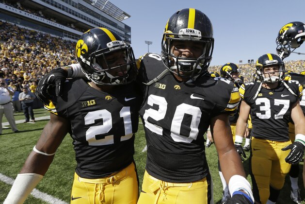 Iowa defensive back Nico Law (21) and linebacker Christian Kirksey (20) celebrate after their 31-13 victory over Minnesota in an NCAA college football game, Saturday, Sept. 29, 2012, in Iowa City, Iowa.  Kirksey returned an interception 68-yards for a touchdown for Iowa in the second half. (AP Photo/Charlie Neibergall)