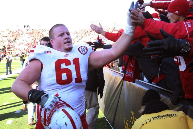 November 23, 2012; Iowa City, IA, USA;  Nebraska Cornhuskers right guard Spencer Long (61) high fives the fans after their game against the Iowa Hawkeyes at Kinnick Stadium. Nebraska beat Iowa 13-7.  Mandatory Credit: Reese Strickland-US PRESS WIRE