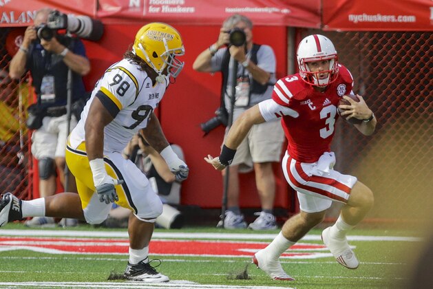 Nebraska quarterback Taylor Martinez (3)  is pursued by Southern Mississippi defensive lineman Khyri Thornton (98) in the first half of an NCAA college football game in Lincoln, Neb., Saturday, Sept. 7, 2013. (AP Photo/Nati Harnik)