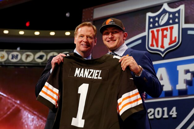 NEW YORK, NY - MAY 08:  Johnny Manziel of the Texas A&M Aggies poses with NFL Commissioner Roger Goodell after he was picked #22 overall by the Cleveland Browns during the first round of the 2014 NFL Draft at Radio City Music Hall on May 8, 2014 in New York City.  (Photo by Elsa/Getty Images)