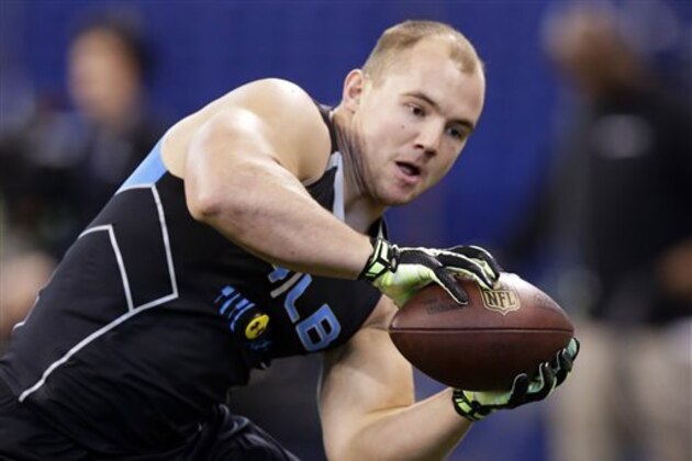 FILE - In this Feb. 24, 2014 file photo, Wisconsin linebacker Chris Borland makes a catch as he runs a drill at the NFL football scouting combine in Indianapolis. Borland is one of the most heralded linebackers to come out of Wisconsin, but questions remain about how his skills might carry over to the NFL. (AP Photo/Michael Conroy, File)