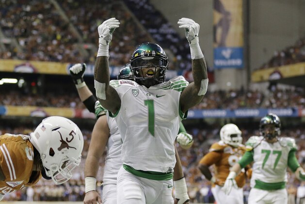 Oregon's Josh Huff (1) celebrates after scoring a touchdown against Texas during the second quarter of the Valero Alamo Bowl NCAA college football game, Monday,  Dec. 30, 2013, in San Antonio. (AP Photo/Eric Gay)