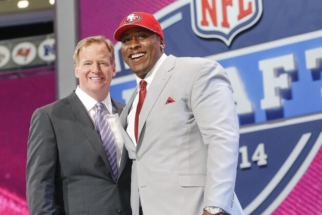 USC center Marcus Martin poses for photos with NFL commissioner Roger Goodell after being selected as the 70th pick by the San Francisco 49ers in the third round of the 2014 NFL Draft, Friday, May 9, 2014, in New York. (AP Photo/Jason DeCrow)