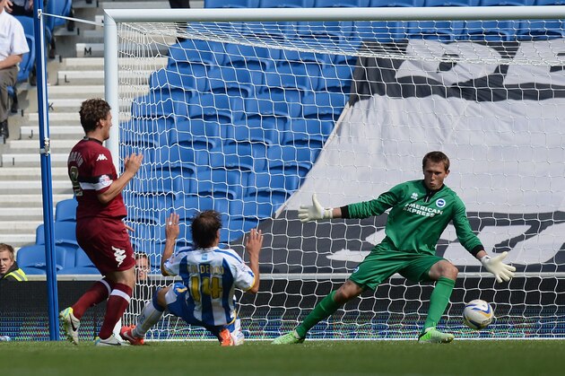 BRIGHTON, ENGLAND - AUGUST 10:  Chris Martin of Derby (L) slots the ball past goalkeeper Tomasz Kuszczak of Brighton during the Sky Bet Championship match between Brighton & Hove Albion and Derby County at Amex Stadium on August 10, 2013 in Brighton, England.  (Photo by Mike Hewitt/Getty Images)