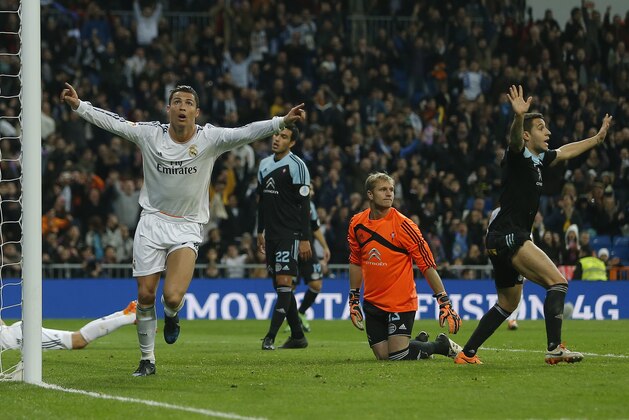 Real Madrid's Cristiano Ronaldo from Portugal, left, celebrates his goal during a Spanish La Liga soccer match between Real Madrid and Celta Vigo at the Santiago Bernabeu stadium in Madrid, Spain, Monday, Jan. 6, 2014. (AP Photo/Andres Kudacki)