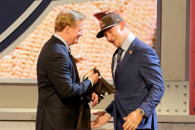 Johnny Manziel hugs NFL Commissioner Roger Goodell after being selected by the Cleveland Browns at the 2014 NFL Draft at Radio City on Thursday, May 8th, 2014 in New York, NY.  (AP Photo/Gregory Payan)