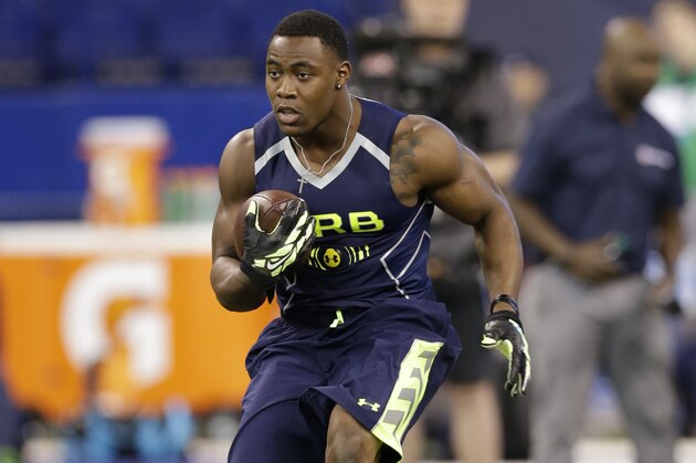Arizona running back Ka'Deem Carey runs a drill at the NFL football scouting combine in Indianapolis, Sunday, Feb. 23, 2014. (AP Photo/Nam Y. Huh)