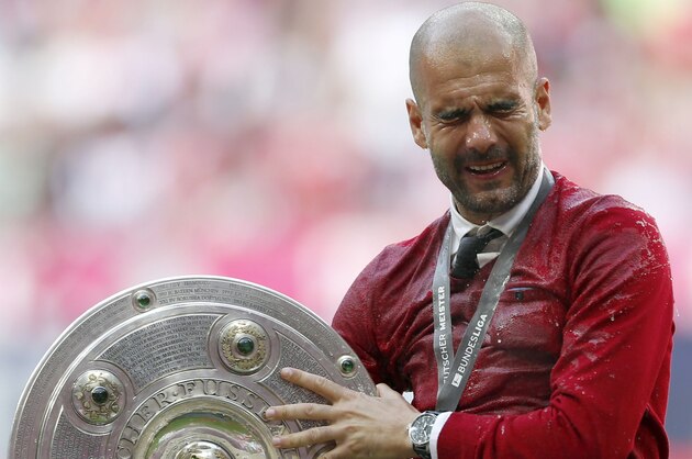 Bayern head coach Pep Guardiola of Spain was showered with beer after winning the German Soccer Championship after the season's last home game between FC Bayern Munich and VfB Stuttgart, in Munich, southern Germany, Saturday, May 10, 2014. (AP Photo/Matthias Schrader)
