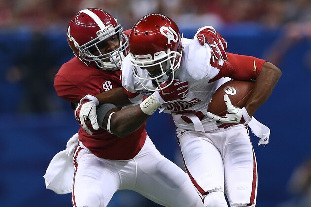 NEW ORLEANS, LA - JANUARY 02:  Jalen Saunders #8 of the Oklahoma Sooners is tackled by Eddie Jackson #4 of the Alabama Crimson Tide during the Allstate Sugar Bowl at the Mercedes-Benz Superdome on January 2, 2014 in New Orleans, Louisiana.  (Photo by Streeter Lecka/Getty Images)
