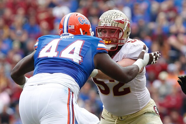 Nov 30, 2013; Gainesville, FL, USA; Florida State Seminoles offensive linesman Bryan Stork (52) blocks Florida Gators defensive lineman Leon Orr (44) during the first quarter at Ben Hill Griffin Stadium. Mandatory Credit: Kim Klement-USA TODAY Sportsw