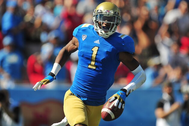 October 13, 2012; Pasadena, CA, USA; UCLA Bruins wide receiver Shaquelle Evans (1) celebrates after he runs the ball for a touchdown against the Utah Utes during the first half at the Rose Bowl. Mandatory Credit: Gary A. Vasquez-USA TODAY Sports