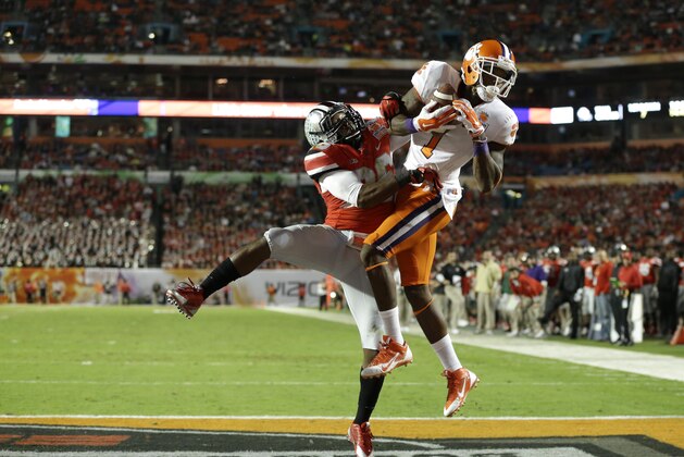Clemson Tigers wide receiver Martavis Bryant (1) makes a catch for a touchdown as Ohio State Buckeyes cornerback Armani Reeves, left, defends during the first half of the Orange Bowl NCAA college football game, Friday, Jan. 3, 2014, in Miami Gardens, Fla. (AP Photo/Wilfredo Lee)