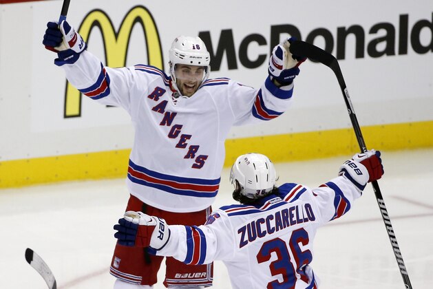 New York Rangers' Derick Brassard (16) celebrates his game-winning goal with teammate Mats Zuccarello (36) in the first overtime period of Game 1 of a second-round NHL hockey playoff series against the Pittsburgh Penguins in Pittsburgh, Friday, May 2, 2014. The Rangers won 3-2. (AP Photo/Gene J. Puskar)