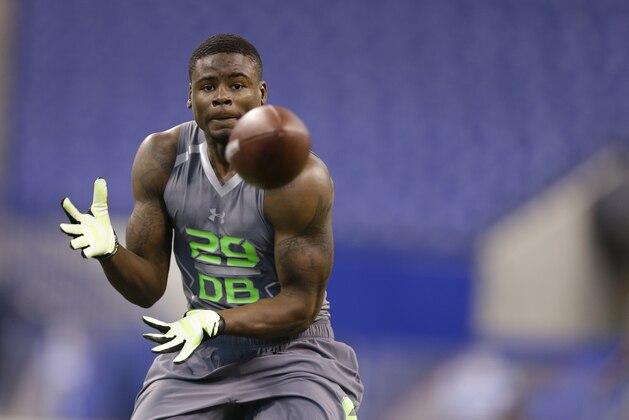 Wyoming defensive back Marqueston Huff runs a drill at the NFL football scouting combine in Indianapolis, Tuesday, Feb. 25, 2014. (AP Photo/Michael Conroy)