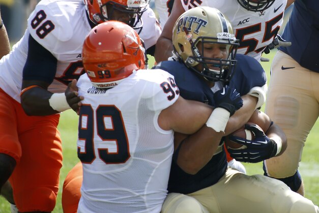 Pittsburgh running back James Conner (40) center is stopped on a run by Virginia defensive tackle Brent Urban (99) and teammates in the first quarter of an NCAA football game Saturday, Sept. 28, 2013 in Pittsburgh. (AP Photo/Keith Srakocic)