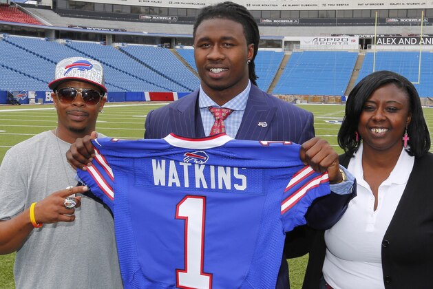 Buffalo Bills first round draft pick Sammy Watkins poses for photos with his father James McMiller, left, and mother Nicole McMiller at Ralph Wilson Stadium in Orchard Park, N.Y., Friday, May 9, 2014. (AP Photo/Bill Wippert)