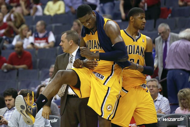 Indiana Pacers center Roy Hibbert (55) celebrates his high scoring game with teammate forward Paul George, right, during the second half of Game 3 of an Eastern Conference semifinal NBA basketball playoff game in Washington, Friday, May 9, 2014. The Pacers won 85-63. (AP Photo/Alex Brandon)