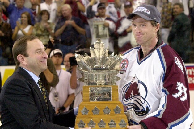 Colorado Avalanche goalie Patrick Roy is presented the Conn Smythe trophy as the most valuable player in the Stanley Cup playoffs by NHL commissioner Gary Bettman after they won the Stanley Cup with a 3-1 win over the New Jersey Devils in Denver on Saturday, June 9, 2001. (AP Photo/Fred Jewell)