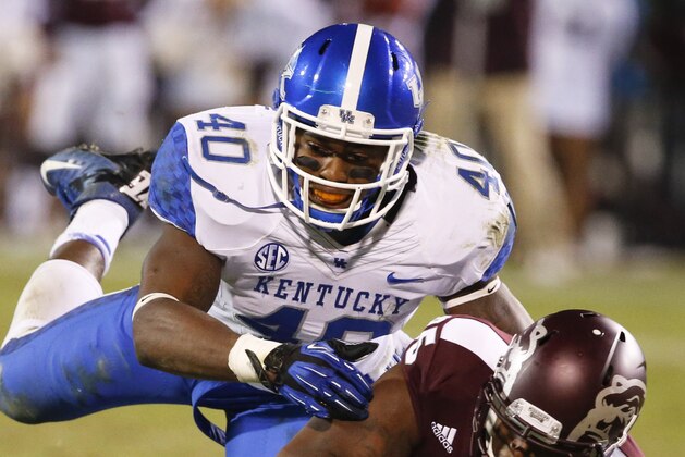 Mississippi State tight end Artimas Samuel (85) protects his pass reception as Kentucky linebacker Avery Williamson (40)dives on him in the second half of their NCAA college football game at Davis Wade Stadium in Starkville, Miss., Thursday, Oct. 24, 2013. Mississippi State won 28-22. (AP Photo/Rogelio V. Solis)