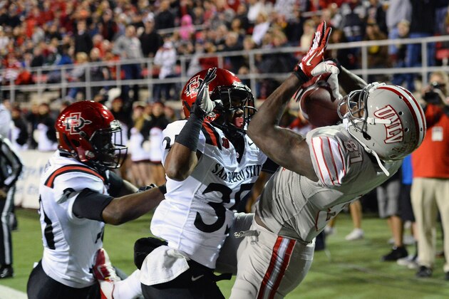 LAS VEGAS, NV - NOVEMBER 30:  Devante Davis #81 of the UNLV Rebels catches a 5-yard touchdown pass in the end zone against King Holder #35 and Nat Berhe #20 of the San Diego State Aztecs during their game at Sam Boyd Stadium on November 30, 2013 in Las Vegas, Nevada.  (Photo by Ethan Miller/Getty Images)