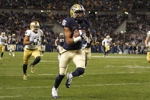 PITTSBURGH, PA - NOVEMBER 09:  Devin Street #15 of the Pittsburgh Panthers breaks a tackle and scores a 63 yard touchdown in the second half against the Notre Dame Fighting Irish during the game on November 9, 2013 at Heinz Field in Pittsburgh, Pennsylvania.  (Photo by Justin K. Aller/Getty Images)